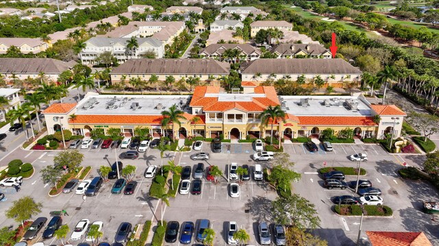 bird's eye view with view of golf course, a water view, and a residential view