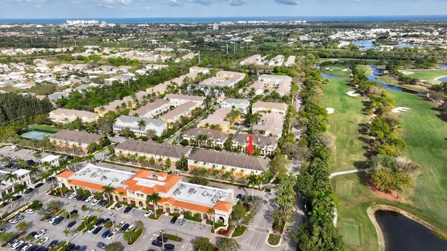 aerial view with a residential view, view of golf course, and a water view