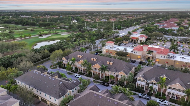 aerial view with a residential view, a water view, and view of golf course