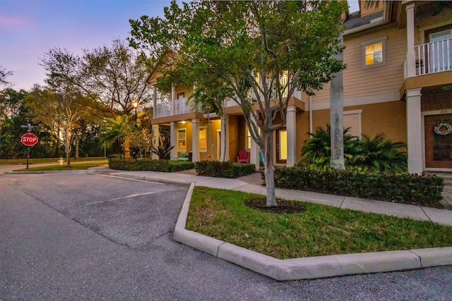 property at dusk with uncovered parking