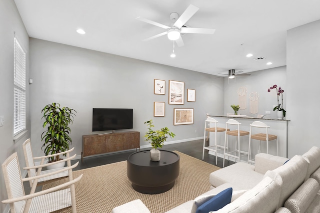 living room featuring visible vents, baseboards, ceiling fan, recessed lighting, and dark wood-style floors