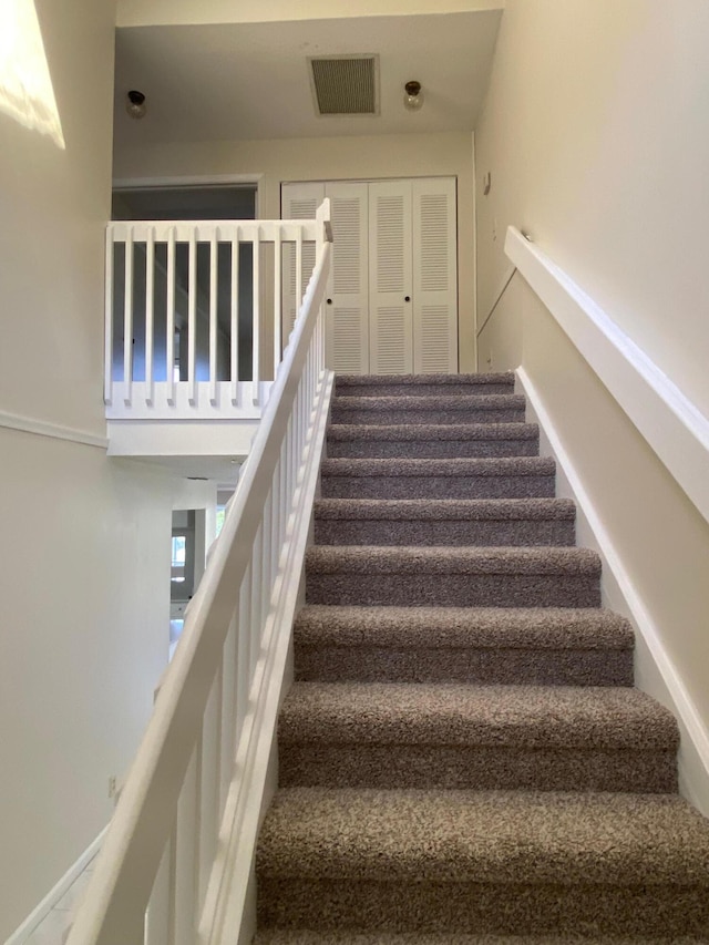 staircase featuring visible vents