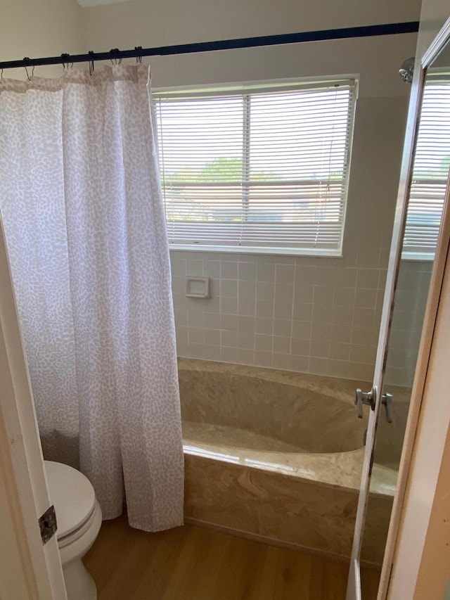 full bath with toilet and wood finished floors