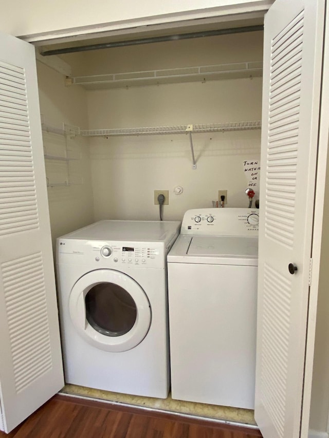 clothes washing area featuring laundry area, dark wood-style floors, and separate washer and dryer