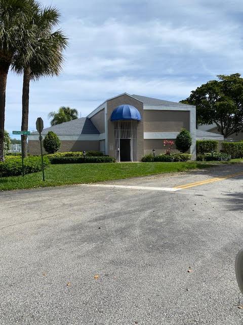 view of building exterior featuring uncovered parking