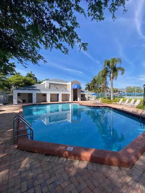 pool featuring fence and a patio