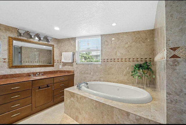 bathroom with tile walls, tile patterned floors, vanity, and a bath