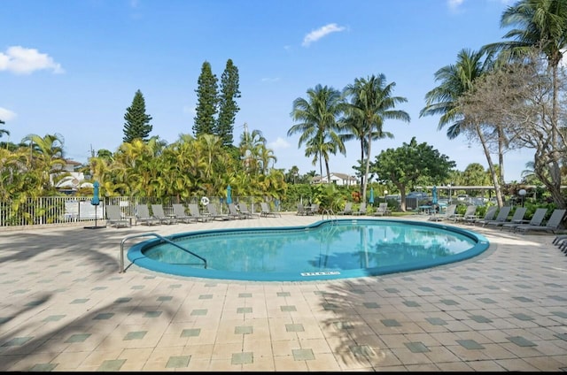 pool featuring a patio area and fence