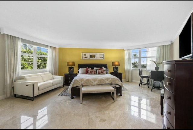 bedroom featuring marble finish floor and baseboards