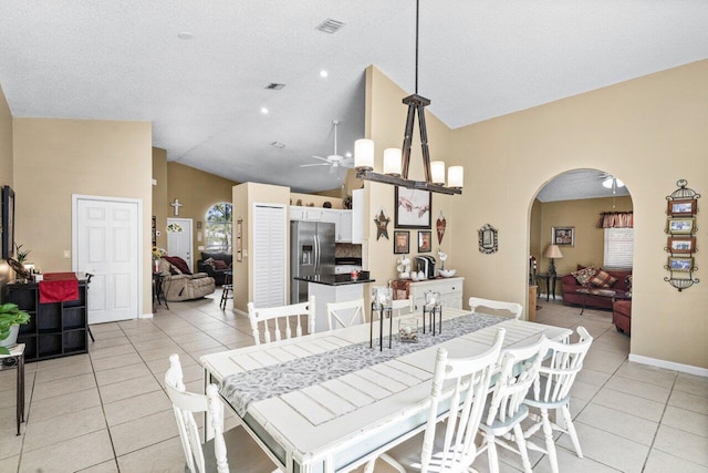 dining room featuring a ceiling fan, arched walkways, visible vents, and light tile patterned floors