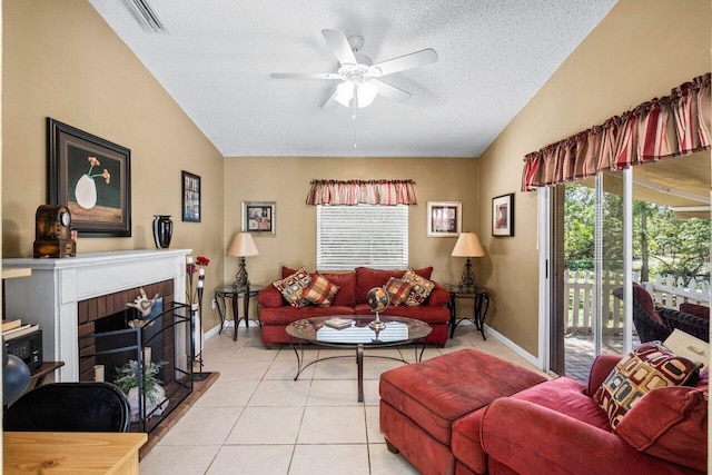 living room with vaulted ceiling, light tile patterned floors, a brick fireplace, and visible vents