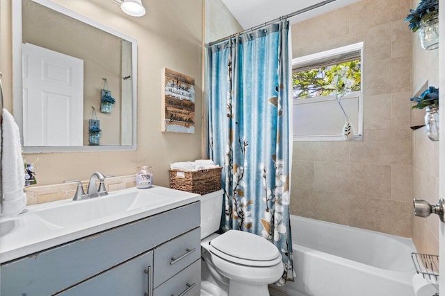 full bathroom featuring shower / bath combo, vanity, and toilet