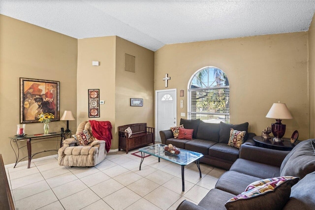 living room featuring light tile patterned floors, a textured ceiling, visible vents, and high vaulted ceiling