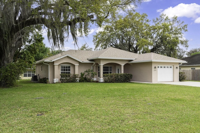 ranch-style home featuring cooling unit, a garage, concrete driveway, stucco siding, and a front lawn