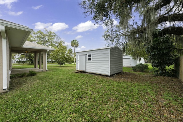 view of yard with an outdoor structure and a shed