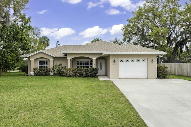 ranch-style home with a garage, concrete driveway, a front lawn, and stucco siding