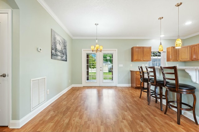 kitchen featuring brown cabinetry, plenty of natural light, visible vents, and light countertops