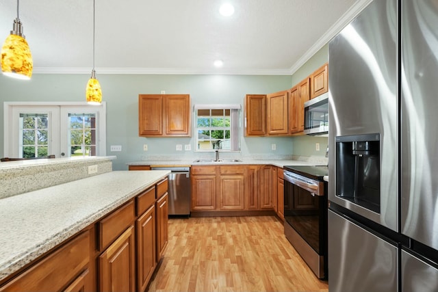 kitchen featuring brown cabinetry, ornamental molding, stainless steel appliances, and french doors