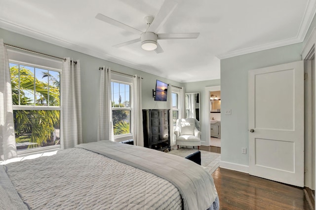 bedroom with connected bathroom, dark wood-type flooring, baseboards, ornamental molding, and a ceiling fan