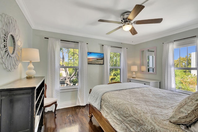 bedroom featuring baseboards, dark wood-type flooring, ornamental molding, and a ceiling fan