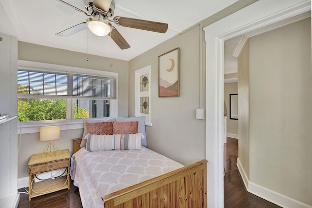 bedroom featuring baseboards, dark wood-style flooring, and ceiling fan