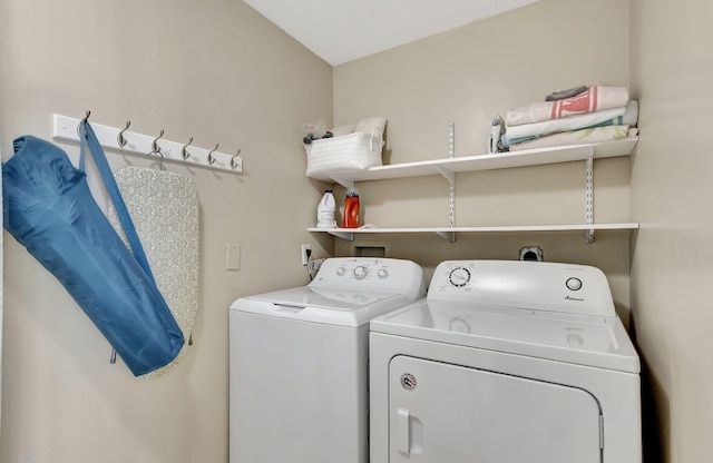 clothes washing area with washing machine and dryer and laundry area