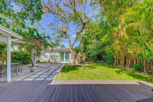 535 28th St, West Palm Beach, FL 33407 - wooden deck with a yard, french doors, and a patio area