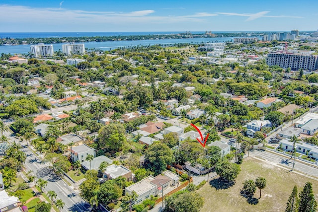 drone / aerial view featuring a water view and a view of city