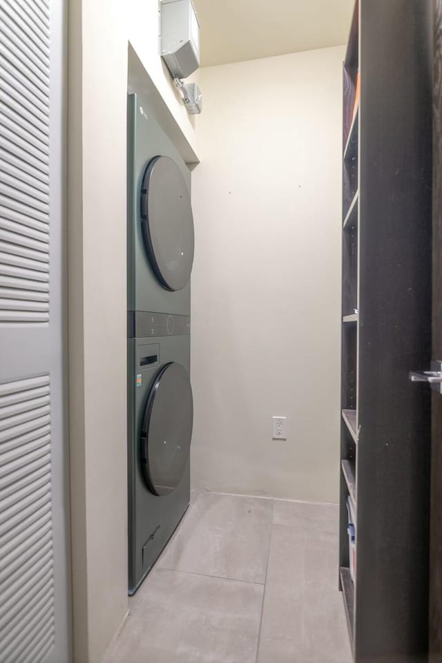 laundry room with laundry area and stacked washer / dryer