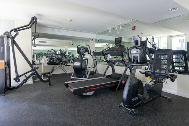 workout area with track lighting and baseboards