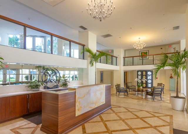 welcome area featuring a notable chandelier and visible vents