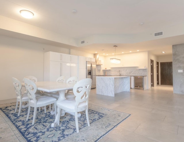 dining space with wine cooler, recessed lighting, and visible vents