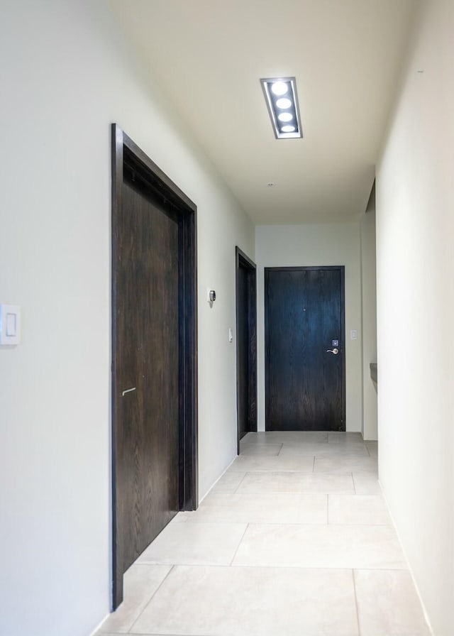 corridor with light tile patterned flooring