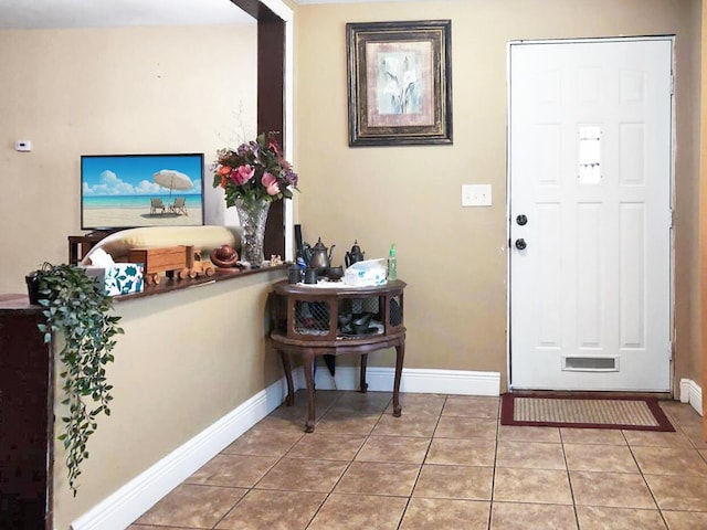 tiled foyer with baseboards