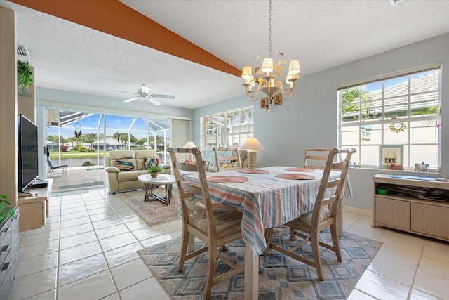 dining area with ceiling fan, a textured ceiling, and light tile patterned flooring