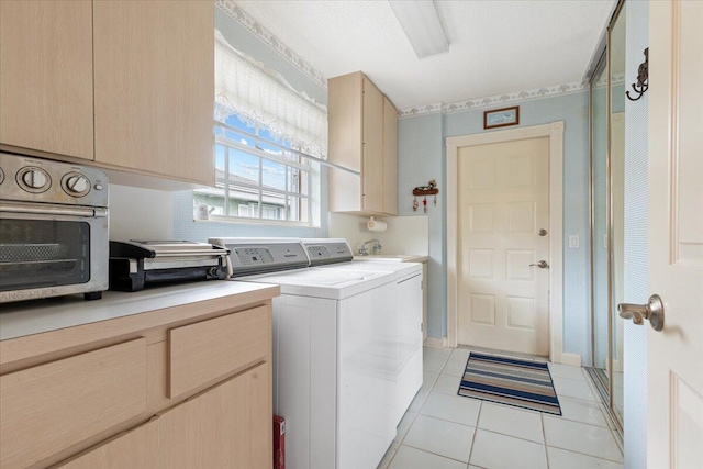 washroom with laundry area, light tile patterned floors, and washer and dryer