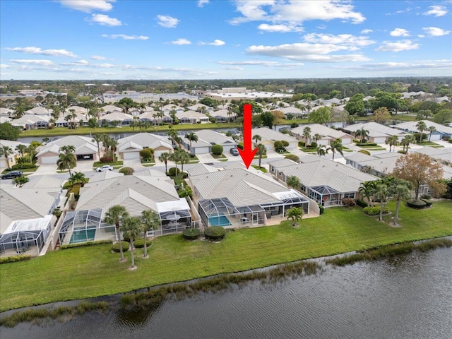 birds eye view of property featuring a water view and a residential view