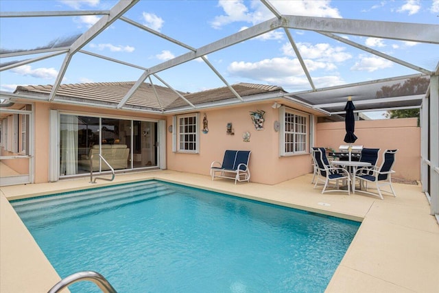 outdoor pool with a patio area