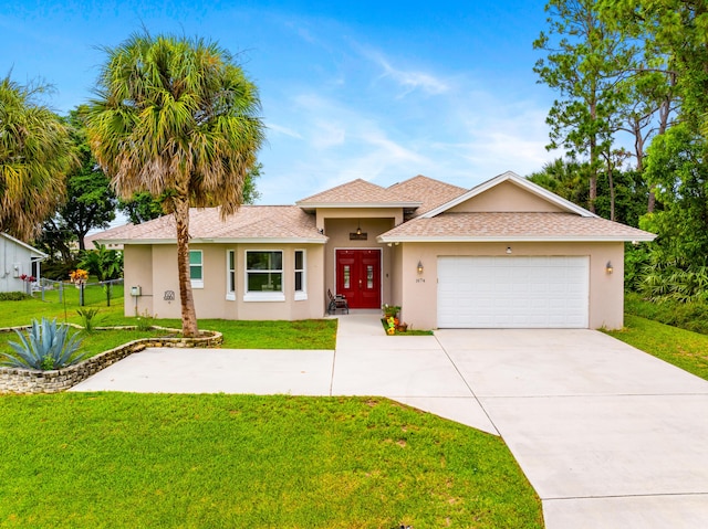 single story home featuring stucco siding, a front lawn, concrete driveway, and an attached garage