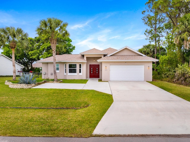 single story home with a shingled roof, a front lawn, stucco siding, a garage, and driveway