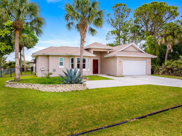 ranch-style home featuring stucco siding, driveway, fence, a front yard, and an attached garage