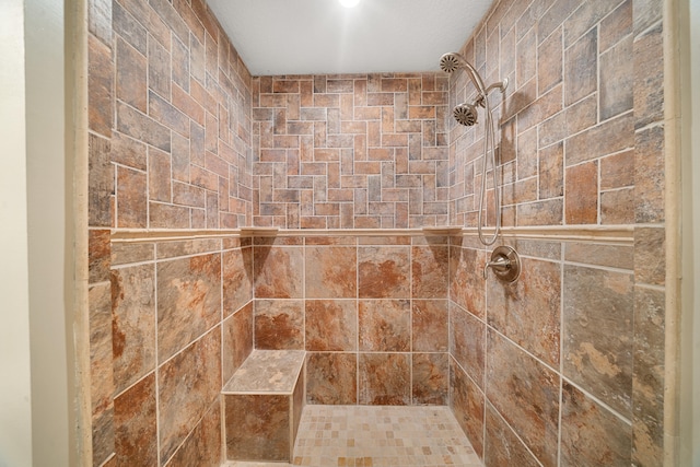 full bath featuring tiled shower