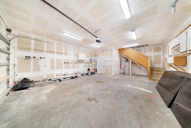 garage with water heater and a garage door opener