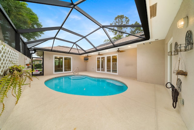 outdoor pool featuring a lanai, a patio area, and ceiling fan