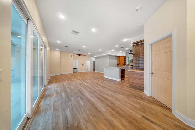 unfurnished living room with baseboards, visible vents, light wood finished floors, recessed lighting, and ceiling fan