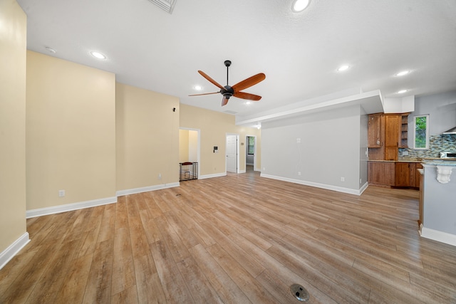 unfurnished living room with recessed lighting, baseboards, light wood-type flooring, and a ceiling fan