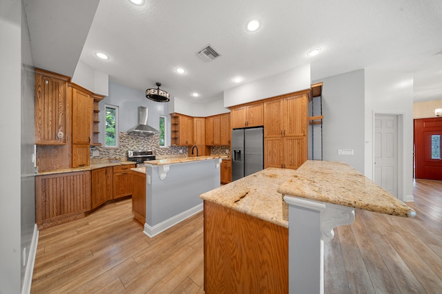 kitchen featuring open shelves, wall chimney exhaust hood, a kitchen island, and stainless steel appliances