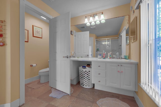 bathroom with visible vents, toilet, a shower stall, vanity, and baseboards