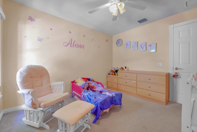 carpeted bedroom with a ceiling fan and visible vents