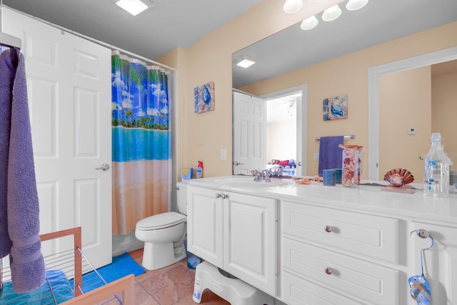 bathroom with toilet, tile patterned floors, curtained shower, and vanity